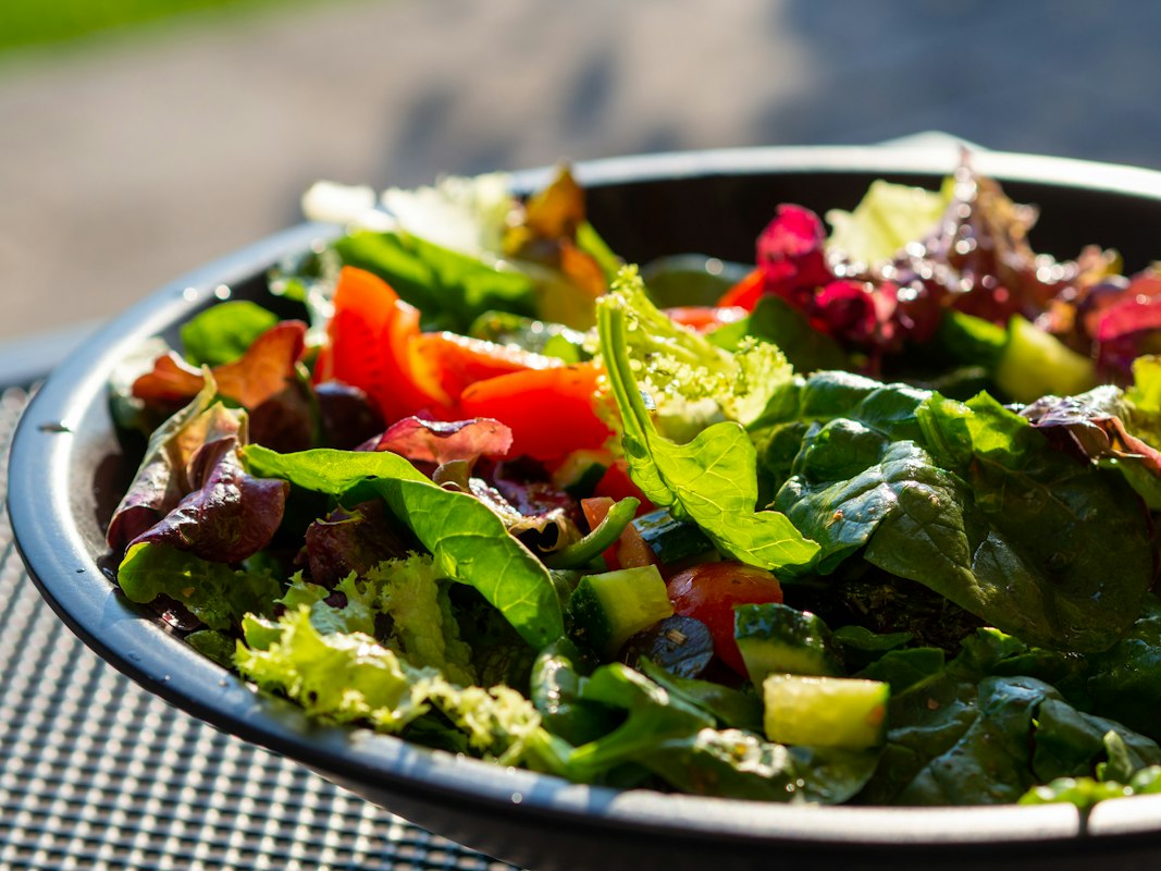 Low-calorie vegetables and healthy foods arranged on a kitchen table
